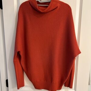 Rust color ribbed asymmetrical sweater.